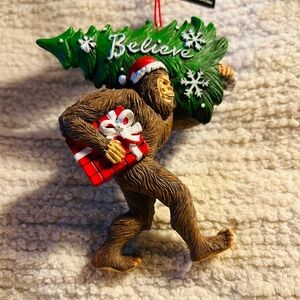 Bigfoot,  Believe ornament wearing a Santa hat. Brand new